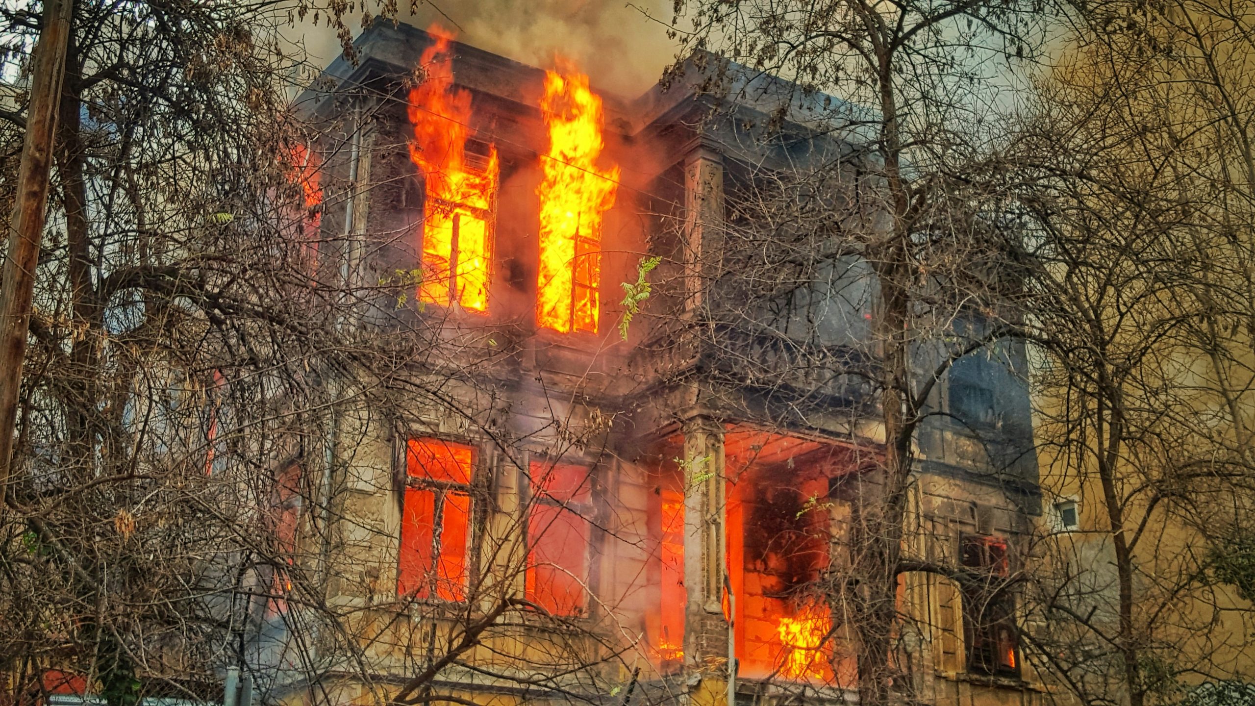 Burning building engulfed in flames, illustrating fire damage, emphasizing the need for professional fire damage restoration services in Long Island.
